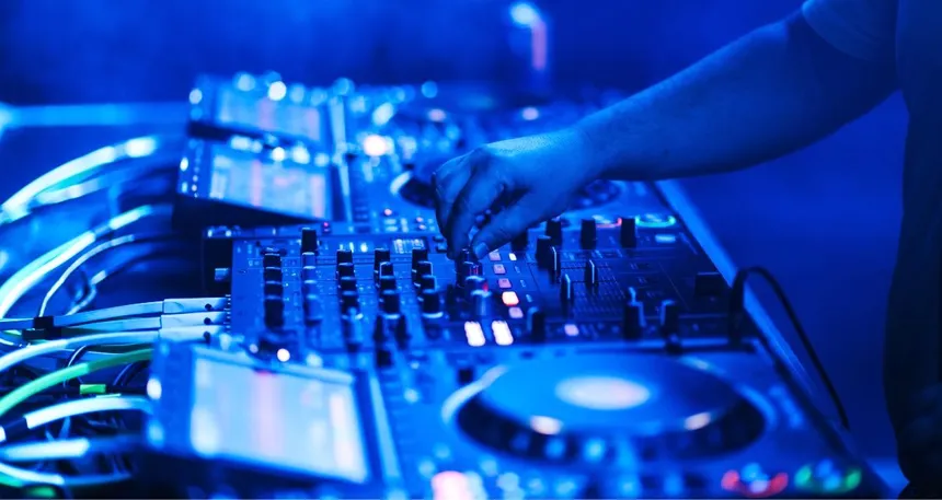A photo of a professional club booth with Pioneer CDJs and a mixer.